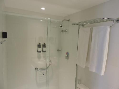 a bathroom with a shower with a glass door at BFC Suíte em Barra da Tijuca in Rio de Janeiro