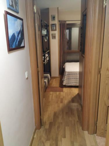 a hallway with a room with a bed and a door at Apartamento en Escarrilla, sallent de gallego in Sallent de Gállego