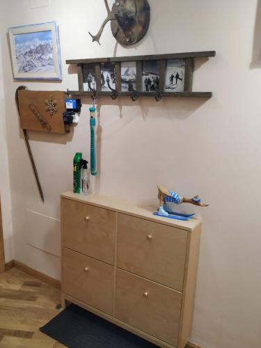 a bedroom with a dresser and a shelf on the wall at Apartamento en Escarrilla, sallent de gallego in Sallent de Gállego