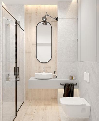 a white bathroom with a sink and a mirror at Hanza Tower City View 13th floor in Szczecin