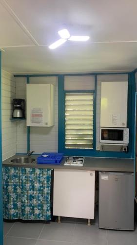 a kitchen with blue cabinets and a counter top at an eol caraibes in Trois-Rivières