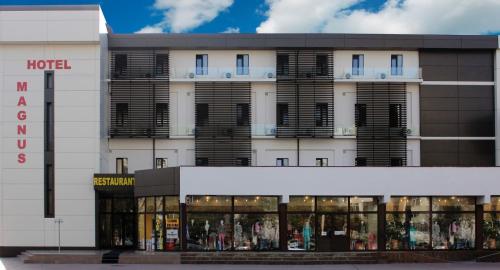a hotel with a store in front of it at Hotel Magnus Galati in Galaţi