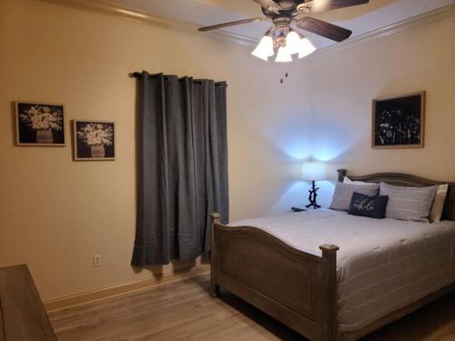 a bedroom with a bed and a ceiling fan at Villa 7 in Hammond