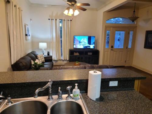 a kitchen with a sink and a living room at Villa 7 in Hammond