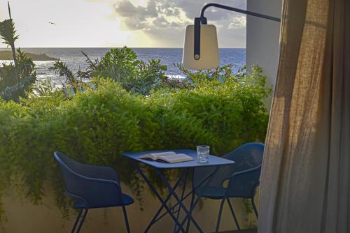 a table and chairs on a balcony overlooking the ocean at Le Martin Boutique Hôtel in Cul de Sac