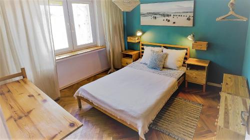 a small bedroom with a bed and a window at Casa del Mare, Apartments and more in Łeba
