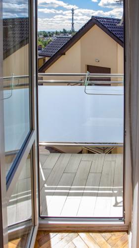 a view from an open window of a balcony at Casa del Mare, Apartments and more in Łeba