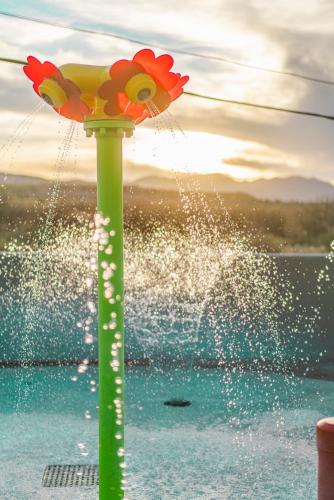 a water fountain with a flower on a pole at Verde Ranch RV Resort in Camp Verde
