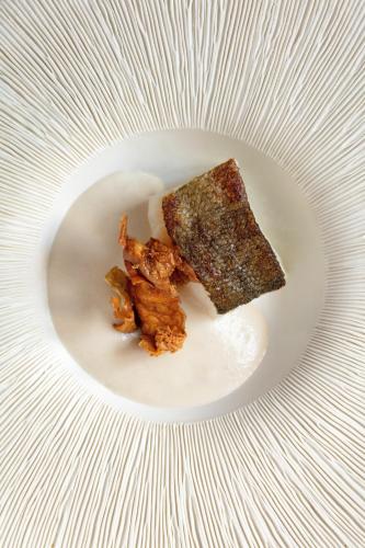 a white plate with a piece of food on it at Le Jardin des Plumes in Giverny