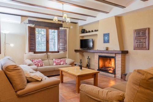 a living room with two couches and a fireplace at Casas rurales Camaretas in Yeste