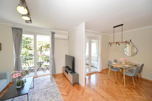a living room with a table and a dining room at The Nest - Urban Family place in Kotor
