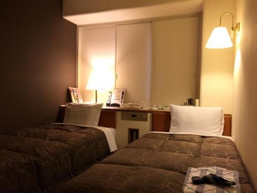 Tempat tidur dalam kamar di Az Inn Fukui - Vacation STAY 65944v