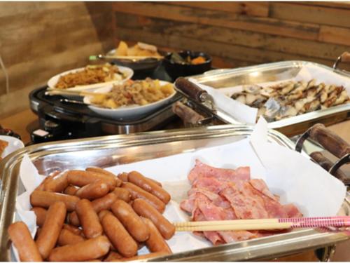 a buffet of food with hot dogs and other foods at Az Inn Fukui - Vacation STAY 65940v in Fukui