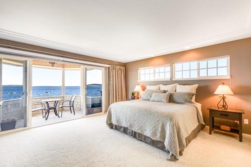 a bedroom with a bed and a view of the ocean at Misty Lady at Water's Edge in Freeland
