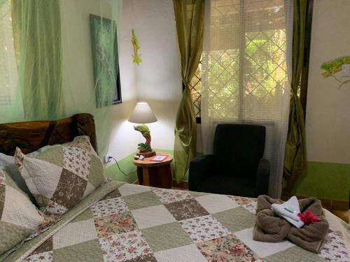 a bedroom with a bed with stuffed animals on it at Cabinas Tito in Cahuita