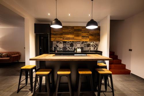 a kitchen with a island with bar stools at Secret Pearls by Matira Beach in Bora Bora
