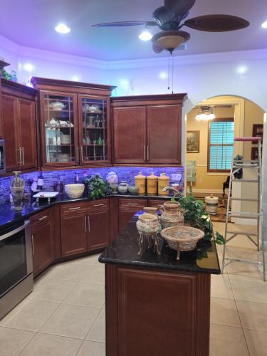 a kitchen with wooden cabinets and a black counter top at Cape Paradise B & B in Cape Coral