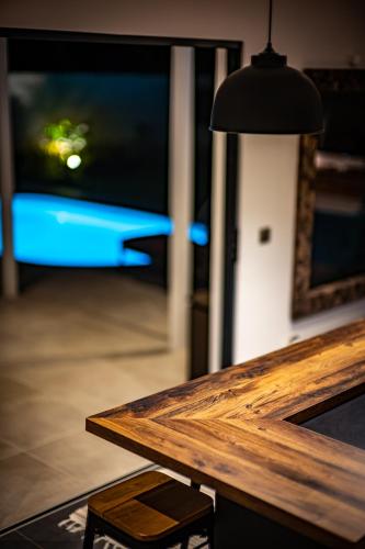 a wooden table with a lamp in a room at Secret Pearls by Matira Beach in Bora Bora