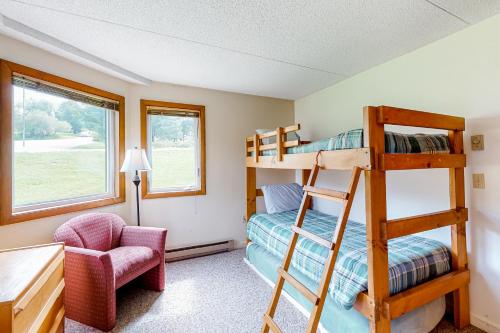 a bedroom with bunk beds and a desk and a chair at Slopeside 705 in Jay