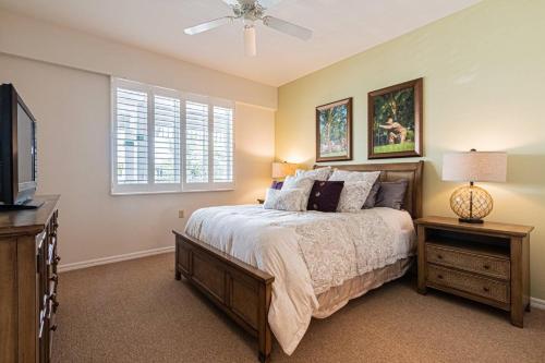 a bedroom with a bed and a tv and a window at Greenlinks-Lely-Building 1200 in Lely Resort