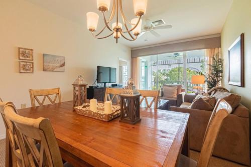 a dining room and living room with a wooden table at Greenlinks-Lely-Building 1200 in Lely Resort