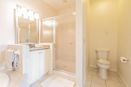 a bathroom with a shower and a toilet at Greenlinks-Lely-Building 1200 in Lely Resort