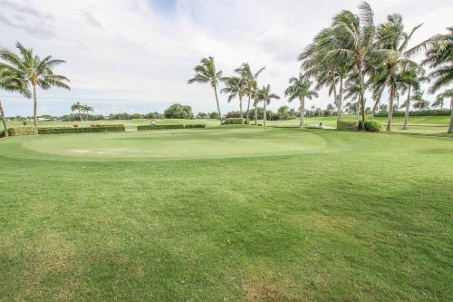 a golf course with palm trees and a green at Greenlinks-Lely-Building 1200 in Lely Resort