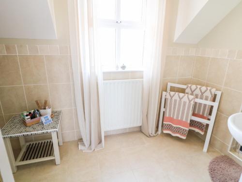 a bathroom with a sink and a window at Stillwaters in Bushmills