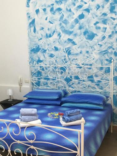 a blue bed with towels on top of it at SEVENTY-FIVE in Castri di Lecce