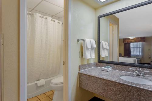 a bathroom with a sink and a toilet and a mirror at Best Western Benton Inn in Benton
