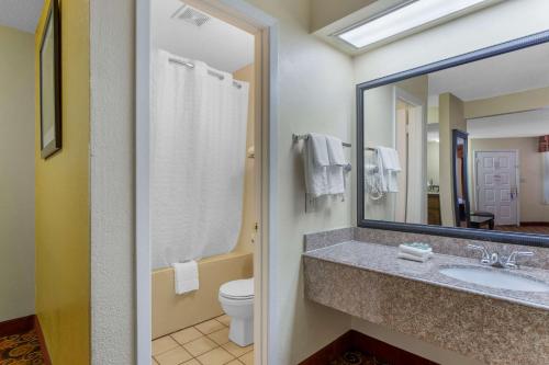 a bathroom with a sink and a toilet and a mirror at Best Western Benton Inn in Benton