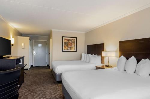 a hotel room with two beds and a flat screen tv at Best Western St Louis Kirkwood Route 66 in Saint Louis