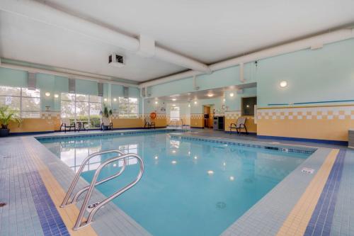 a swimming pool with a chair in the middle of it at Best Western PLUS Chemainus Inn in Chemainus