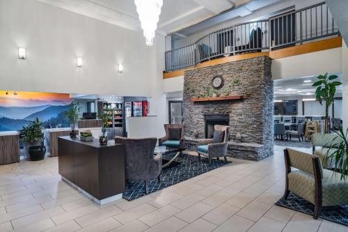 a lobby with a stone fireplace in a office at La Quinta by Wyndham Sevierville / Kodak in Sevierville