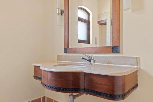 a bathroom with a sink and a mirror at Radisson Blu Resort El Quseir in Quseir