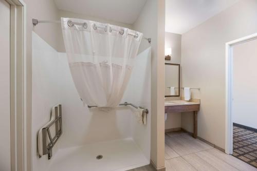 a bathroom with a shower with a shower curtain at Best Western North Bryant Inn in San Angelo