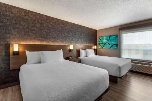a hotel room with two beds and a window at Best Western Plus West Edmonton in Edmonton