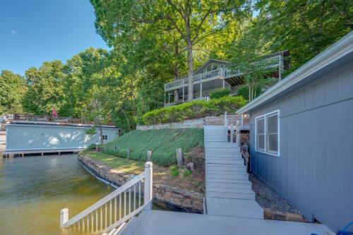 a house with a staircase next to a body of water at Lake Al'Lure in Lake Lure