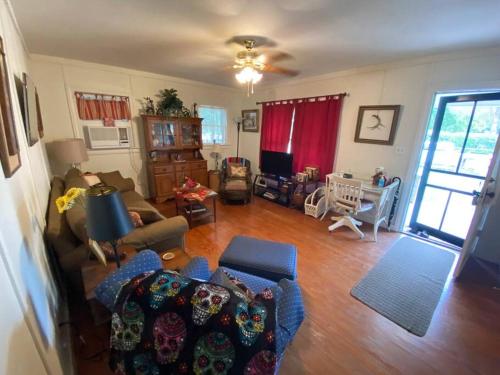 a living room with a couch and a tv at 11th St. Casa Blanca Bandera, TX. in Bandera