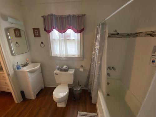 a bathroom with a toilet and a sink and a shower at 11th St. Casa Blanca Bandera, TX. in Bandera
