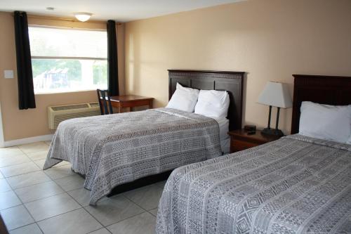 Habitación de hotel con 2 camas y ventana en Rockbridge Inn, en Lexington