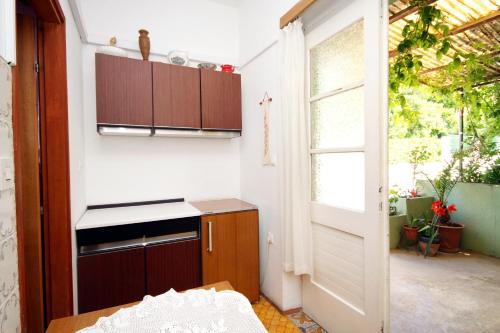 a small kitchen with a sink and a window at Apartment Jelsa 4602c in Jelsa