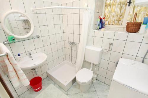 a white bathroom with a toilet and a sink at Holiday house with WiFi Dol, Brac - 5674 in Postira