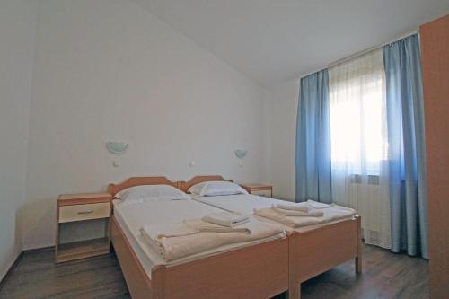 a bedroom with a bed and a window at Apartments by the sea Vinjerac, Zadar - 5811 in Vinjerac