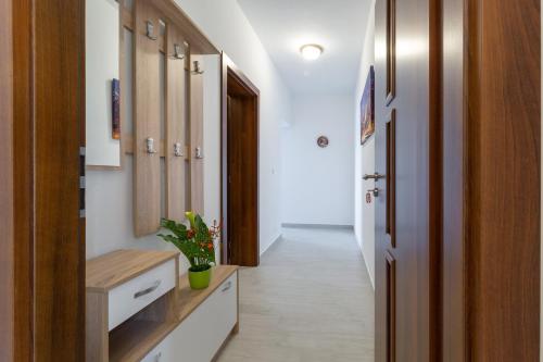 a hallway with a bathroom with a sink and a mirror at Family friendly seaside apartments Kozino, Zadar - 5756 in Petrcane