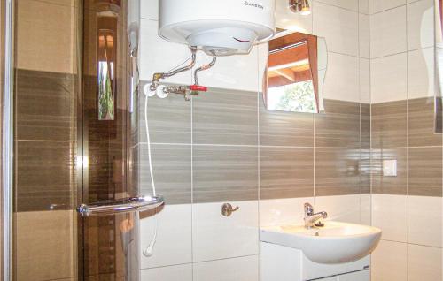 a bathroom with a shower and a sink and a light at Beautiful Home In Sianozety With 2 Bedrooms And Wifi in Sianozety