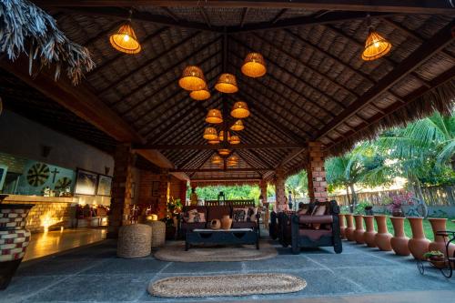 a rendering of a resort lobby with a wooden ceiling at Hotel Pousada Rancho das Dunas in Santo Amaro