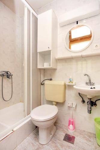 a bathroom with a toilet and a sink at Apartments by the sea Cove Bristova, Hvar - 5716 in Bogomolje