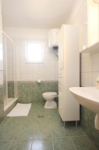 a bathroom with a toilet and a sink at Apartments by the sea Kneza, Korcula - 4342 in Račišće
