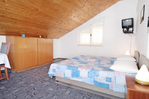 a bedroom with a bed and a wooden ceiling at Studio Vrsi - Mulo 5796b in Vrsi